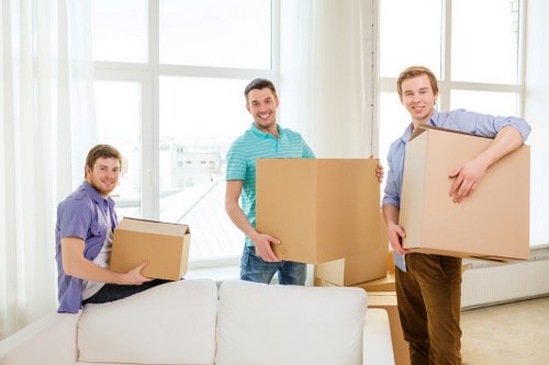 Staff using safe lifting techniques during a removal