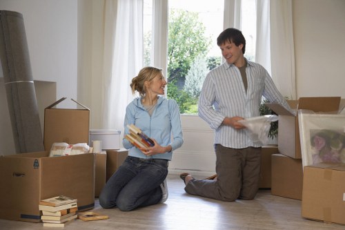 Local office removals team handling furniture in a central London building